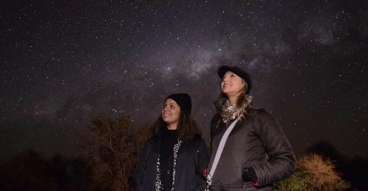A guide pointing a laser at the southern night sky during an Atacama Desert stargazing tour near San Pedro de Atacama, Chile